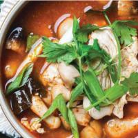 Tom Yum Soup with Chicken · Our spicy-sour soup is served simmering with straw mushrooms, lemon grass, galangal, green o...