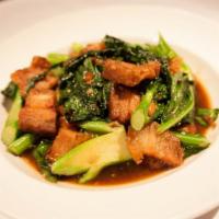 Kana Moo Krob · Following a traditional Thai recipe, pieces of pork belly are fried extra crispy, then tosse...