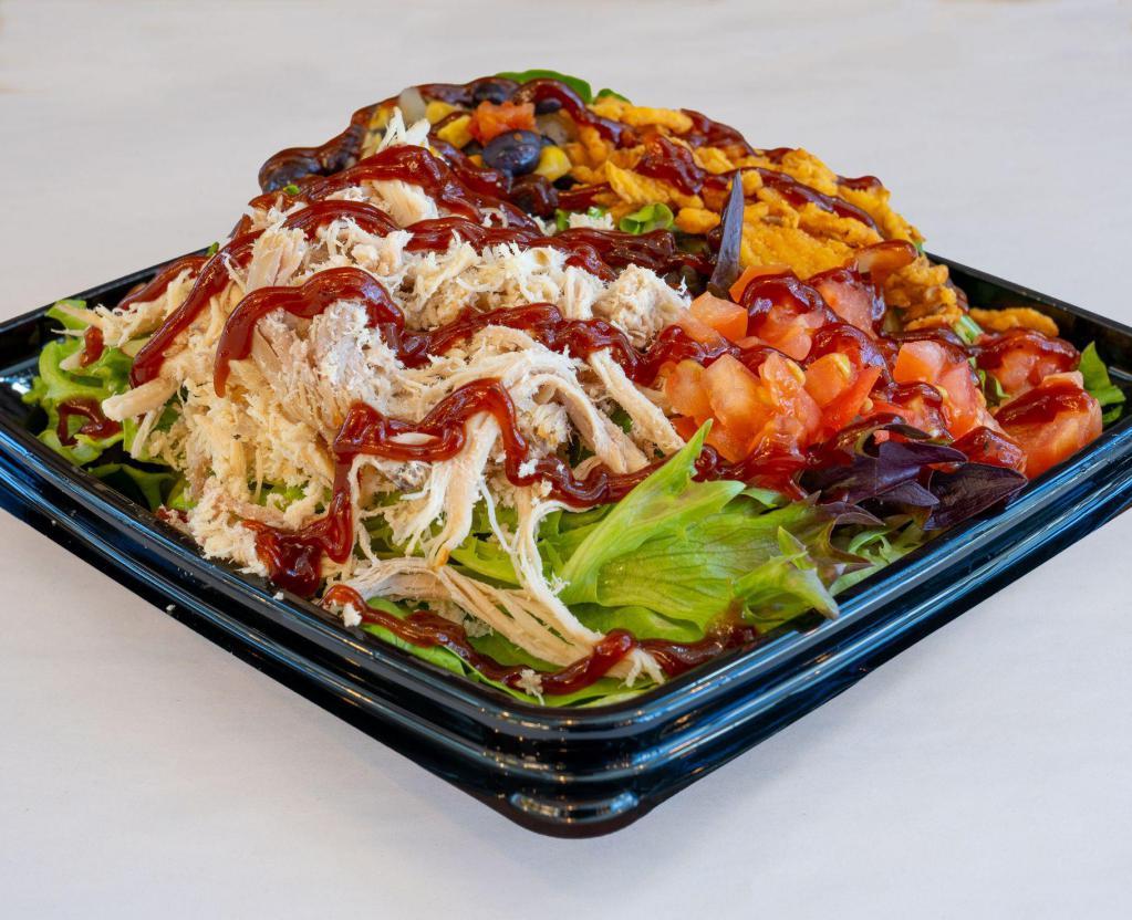 BBQ Turkey Salad · Slow roasted turkey, mixed greens, crispy cheddar onions, diced tomatoes, corn and black bean mix, chipotle ranch dressing and BBQ sauce.