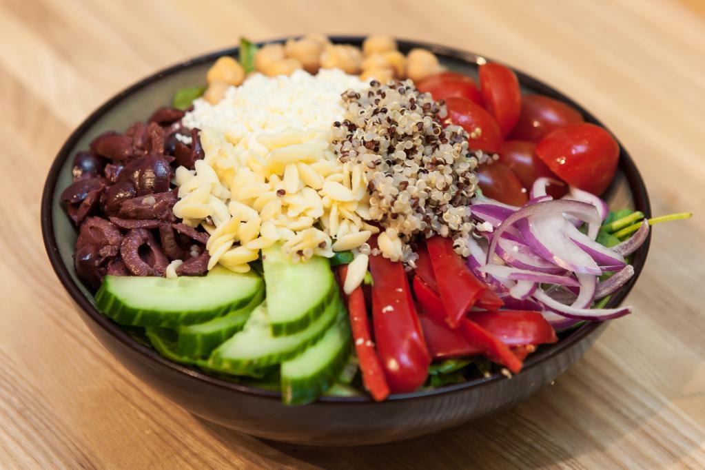 Mighty Aphrodite · Orzo, organic tri-color quinoa, cucumbers, red bell peppers, teardrop tomatoes, Kalamata olives, chickpeas, red onions, feta cheese, romaine and baby spinach; fresh lemon oregano dressing.