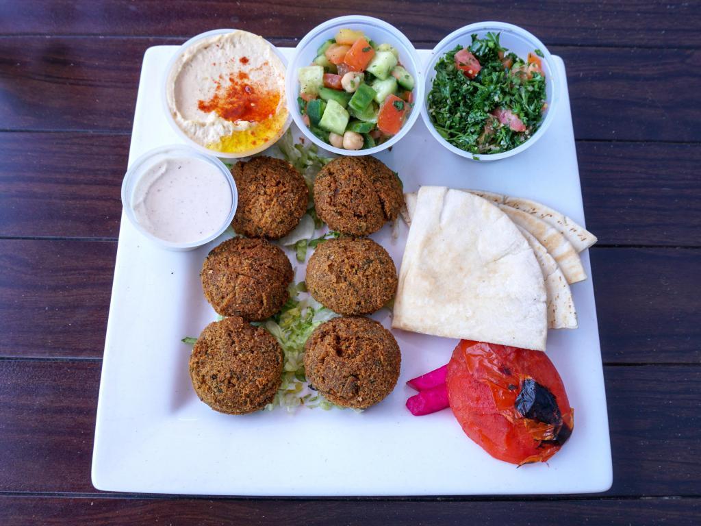 Falafel Plate · With your choice of 3 sides. Ground, spiced chickpeas deep fried to a golden crisp on the outside and tender on the inside. Served with pita bread, grilled tomato and your choice of 3 Sahara sides. Vegetarian. For Vegan, Request without Tahini Sauce