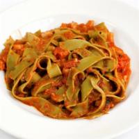 Pappardelle all' Osteria · Spinach ribbon pasta, prosciutto, pomodoro and mushrooms.
