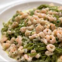 Taglierini Verdi con Gamberetti · Thin spinach pasta, shrimp, garlic and cream.