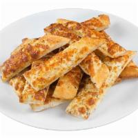 Cheesy Breadsticks · Oven-baked bread sticks glazed in rich garlic butter and oregano and covered in a thick laye...