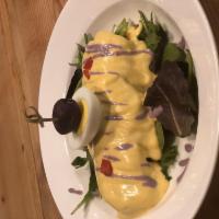 Papa a la Huancaina · Boiled potato on a bed of lettuce with spicy and creamy dressing.