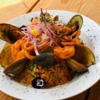 Arroz con Mariscos · Peruvian style paella, scallops, octopus, mussels, shrimp, squid in a red sauce. Topped with...