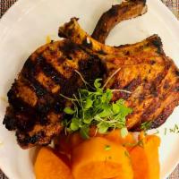Pork Chops · Pork Chops marinated in Peruvian spices served with rice, beans and salad 