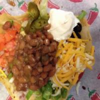 Taco Salad · Crisp greens served in a fried flour tortilla shell. Topped with tomatoes, onions, sour crea...