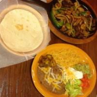 Beef and Chicken Fajitas · Fresh grilled peppers, onions, beef and chicken served sizzling with two flour tortillas, so...