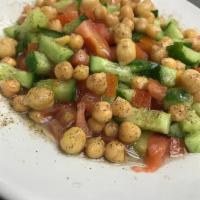 Petrino Salad · Garbanzo beans, chopped tomato, cucumber and onion. Dressed with lemon juice, olive oil and ...