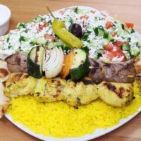 Beef Kabob Plate · Served with yellow rice Greek salad, hot pita, 1 skewer of vegetable and 2 skewers of tender...