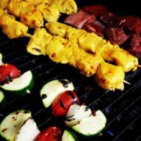 Vegetable Skewers · A skewer of veg sliced ( two Zucchini, one onion, one Tomato) grilled