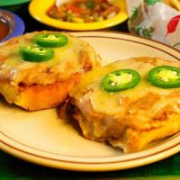 Molletes · Toasted bolillo split in 1/2 and topped with refried beans, melted cheese and jalapenos.