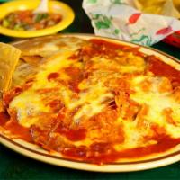 Chilaquiles · Red or green cheese chilaquiles, served with refried beans.