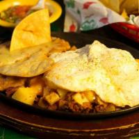 La Morena Chorizo Skillet · 2 eggs (any style) and potatoes with chorizo, topped with cheese, served with refried beans.