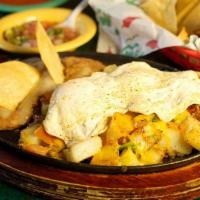 La Morena Mexican Skillet · 2 eggs (any style) and potatoes a la Mexicana, served with refried beans topped with cheese.
