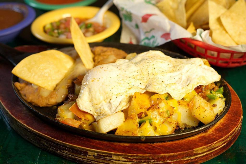 La Morena Mexican Skillet · 2 eggs (any style) and potatoes a la Mexicana, served with refried beans topped with cheese.