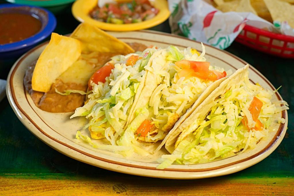 Breakfast Tacos · 3 to an order. Your choice of (unfried) corn or flour tortilla with egg and chorizo, egg and ham, or egg and potato. Served  whole beans on the side. Tacos stuffed with lettuce, cheese and tomato.