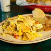 Migas · Fried corn chips, mixed with long green chile, onion, tomato.Served with two scrambled eggs ...