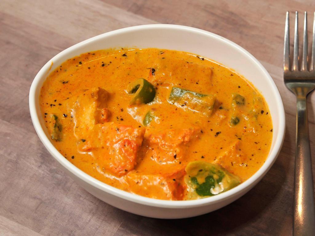 Chicken Tikka Masala · Boneless grilled chicken cooked with tomato, cream and special spices. A divine buttery taste.