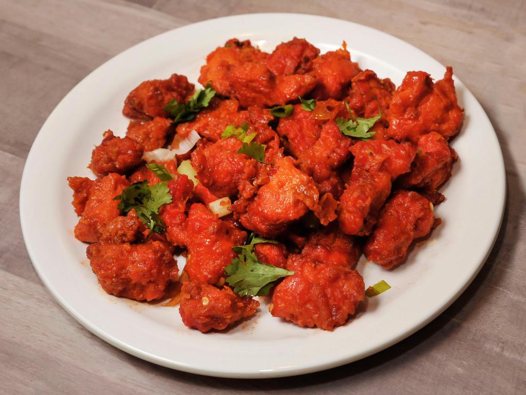 Chicken Manchurian · Wet. Battered chicken sauteed with onions, bell peppers and soya sauce.