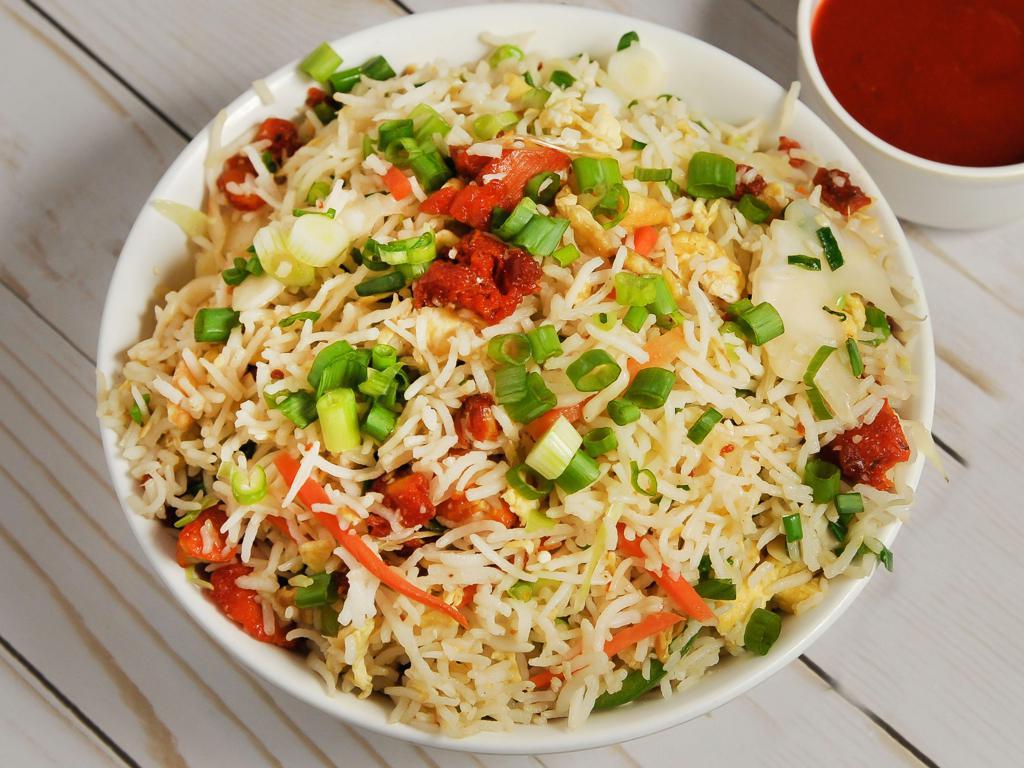 Chicken Fried Rice · Aromatic rice stir fried with fine chopped cabbage, carrots, bell peppers and chicken.