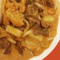 Massaman Curry · Medium spicy. Massaman curry, coconut milk, onion, peanuts, potato and meat. 