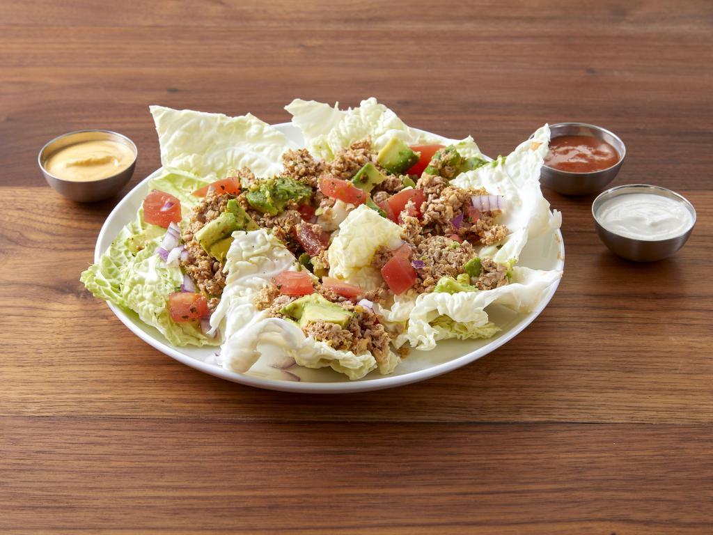 Nachos · Fresh cabbage chips topped with walnut meat, spicy red sauce, pumpkin seed 