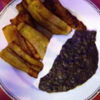 Plantanos Fritos · Fresh ripe Fried plantains served with refried black beans and sour cream.