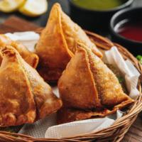 Vegetable Samosa · Crispy, deep fried pastry, filled with potatoes and green peas flavored with fresh spices. V...