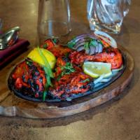 Chicken Tandoori · Chicken delicately marinated in fresh aromatic spices and herbs and tenderly cooked in tradi...