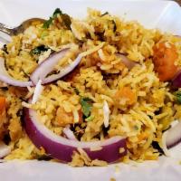 Vegetable Biryani · Basmati rice cooked with fresh vegetables and saffron, sprinkled with raisins and nuts. Vege...