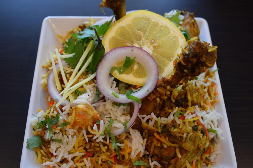 Chicken Biryani · A traditionally cooked basmati rice with chicken, Indian herbs and garnished with saffron.