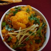 Aloo Gobi Masala · Fresh cauliflower and potatoes, cooked with onions, tomatoes and north Indian seasonings. Ve...
