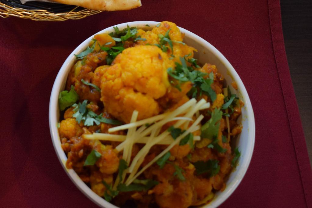 Aloo Gobi Masala · Fresh cauliflower and potatoes, cooked with onions, tomatoes and north Indian seasonings. Vegetarian.