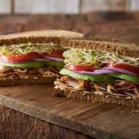 Pilgrim's Progress Sandwich · Slices of turkey breast and avocado on hearty 9-grain bread with onions, tomato, clover spro...