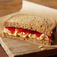 Annie Ankle Biter Kid's Meal · Half of a peanut butter and strawberry preserves sandwich on hearty 9-grain bread. Served wi...