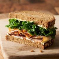Kids Tommy Turkey · 1/2 of a turkey breast sandwich with lettuce and Erik's secret goo on hearty 9-grain bread.