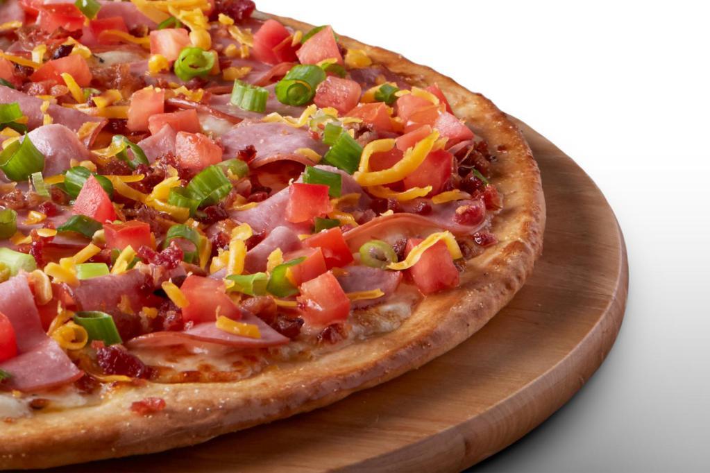 Gluten-Free Crunchy Club Pizza · Signature garlic white sauce topped with mozzarella and cheddar cheeses, Canadian bacon, smoked bacon, fresh Roma tomatoes, and green onions.