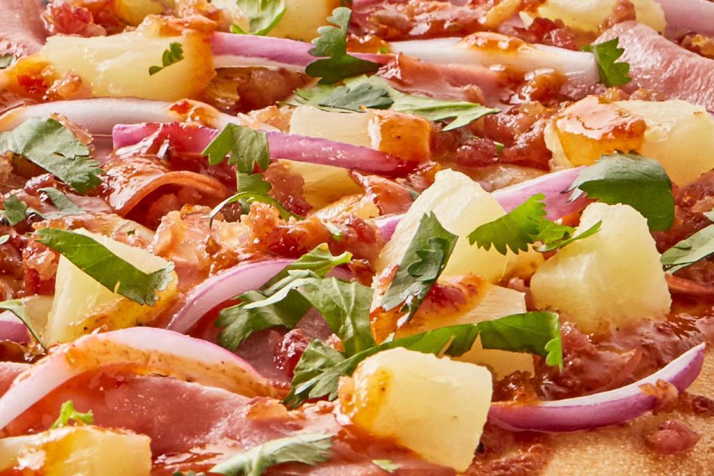 Serrano Chili Pizza · Serrano Chili sauce drizzled over Canadian style bacon, Applewood smoked bacon, sweet red onions, Dole pineapple chunks & mozzarella cheese, topped off with fresh cilantro.