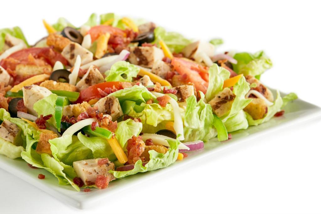 Chicken Bacon Ranch Salad · Bacon, chicken, iceberg lettuce, bell peppers, red onions, black olives, Roma tomatoes, mozzarella cheese, cheddar cheese, seasoned croutons and dressing.