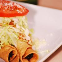 Mini Taco Hondureno (1) · 1 piece. Fried rolled taco stuffed with chicken and covered with cabbage, cheese and tomatoe...