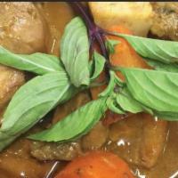 Sophisticated Golden Chicken · Chicken, potato, yam, carrots simmered in curry, ginger, basil coconut milk broth served wit...