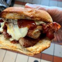 The Cumare · Fried chicken cutlet, crispy bacon, BBQ sauce, melted mozzarella cheese on a toasted garlic ...