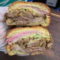 Cubano · Roast pork, ham, Swiss cheese, pickles topped with spicy mustard.