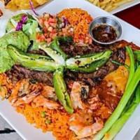 Carne con Camarones · A juicy beef sirloin cooked to perfection, accompanied with garlic grilled shrimp. Served wi...
