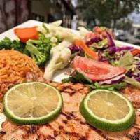 Pollo al Chipotle · Grilled marinated chicken breast with a special chipotle sauce; served with rice and steamed...