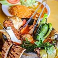 Cabrera's Molcajete · Choice of grilled steak, chicken or shrimp combo. Placed on a bed of cactus with panela chee...