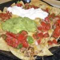 Nachos · Chips, cheese, choice of black or pinto beans, guacamole, pico and sour cream.