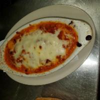 Cheese Ravioli · Baked ravioli filled mozzarella and ricotta cheese cooked with our NY marinara sauce.
